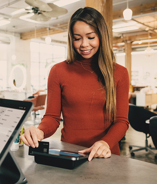Kunde zahlt an einem POS-Terminal in einem Geschäft mit Karte